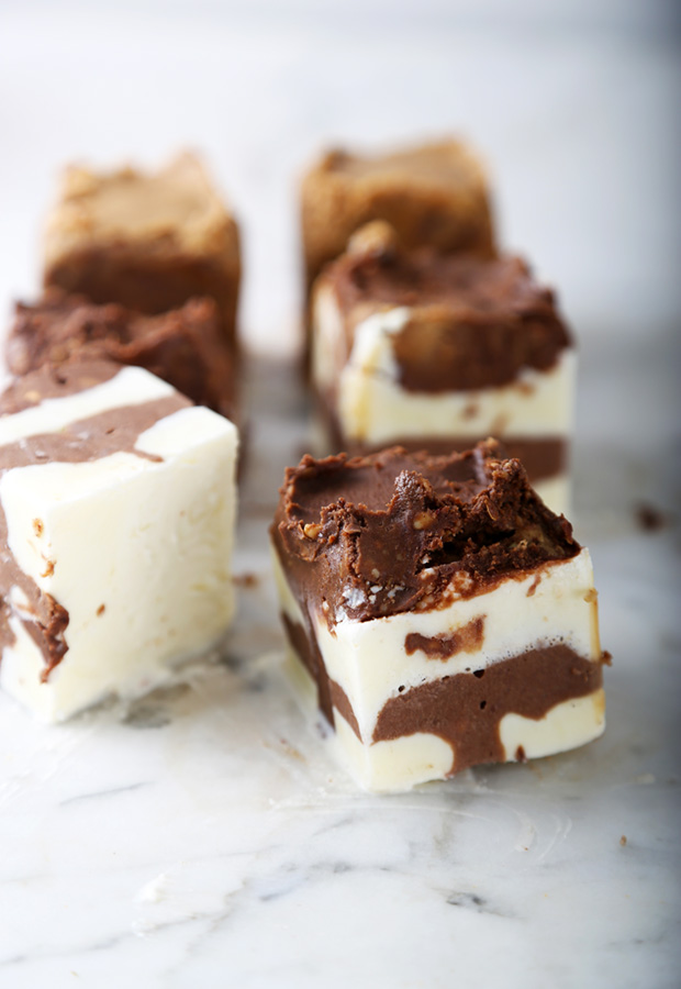 Frozen fat bombs with swirled chocolate and vanilla layers cut into squares on marble