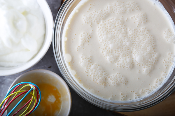 Frothy eggnog base after folding egg whites into heavy cream and coconut milk