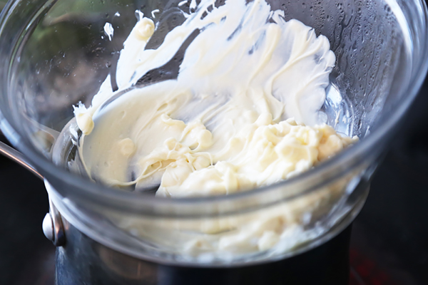 Melted cocoa butter turned smooth and glossy in the double boiler glass bowl