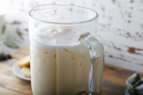 Chilled ketoproof green tea with frothy top in a glass pitcher after freezing