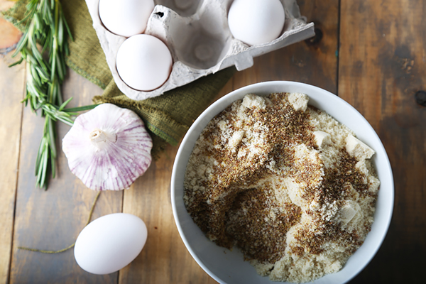 Flaxseed meal and red pepper flakes mixed into almond flour in a white bowl
