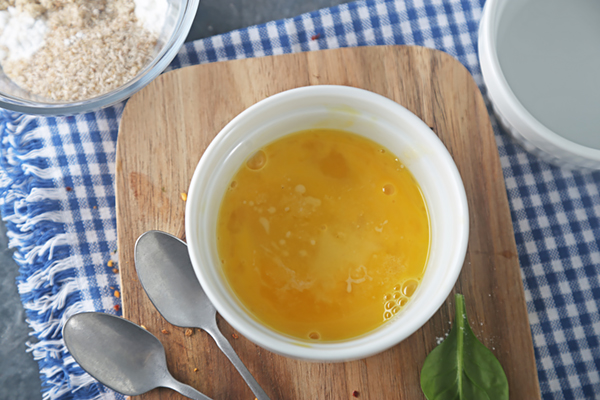 Melted butter whisked into egg in a ramekin, turning the mixture golden