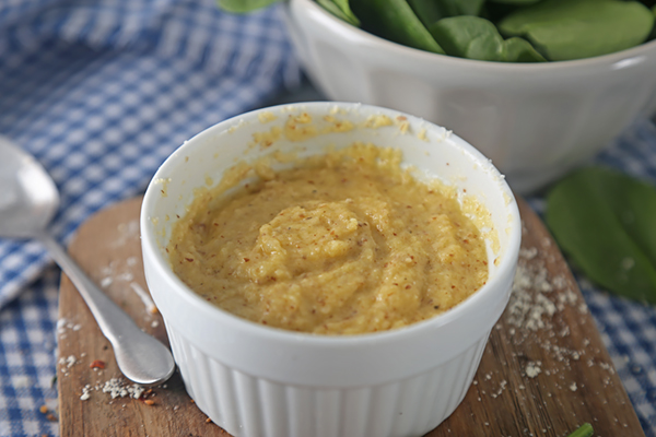 Thick bun dough mixed smooth in a ramekin with speckled psyllium husk texture