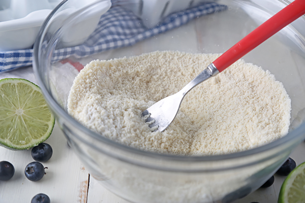 Almond flour, coconut flour, and baking powder whisked together in a glass bowl