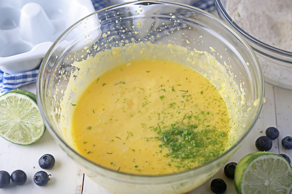 Lime zest and juice stirred into the pale yellow cake batter