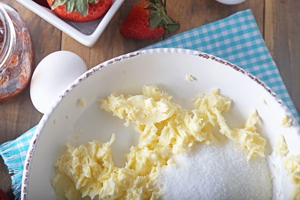 Creamed butter and erythritol in a white mixing bowl before blending