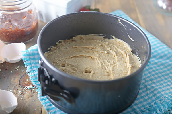 Smooth shortcake batter spread into a greased round baking pan