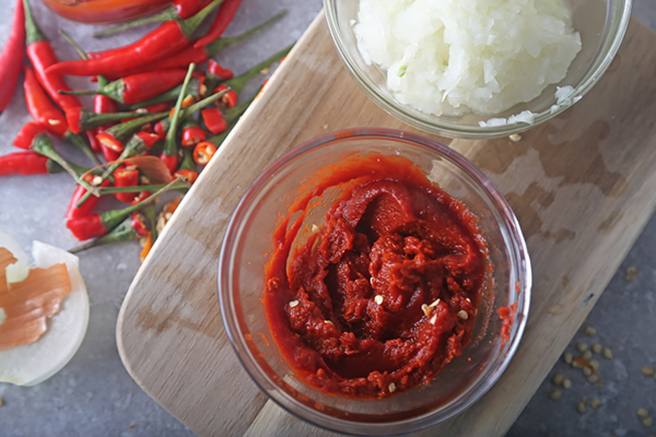 Thick red chile paste blended from bird's eye peppers beside the onion paste