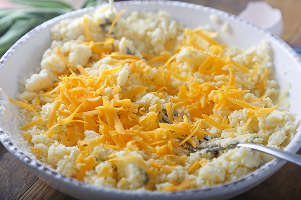 Shredded cheddar folded into the thick coconut flour waffle batter