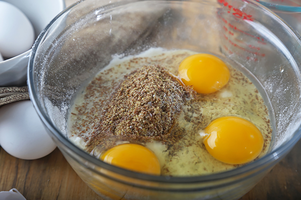 Eggs, water, and apple cider vinegar added to the coconut flour and flaxseed mixture