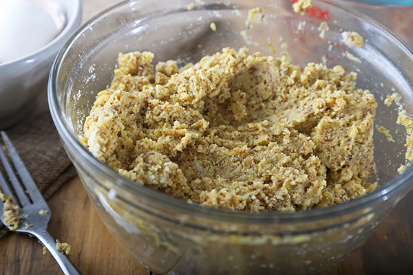 Thick keto bread batter with coconut flour and flaxseed meal in a glass bowl