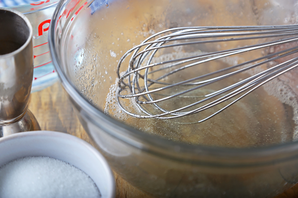 Whisking coconut extract and powdered erythritol into the warm gelatin mixture