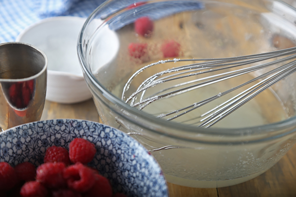 Clear rum stirred into the gelatin mixture with fresh raspberries alongside