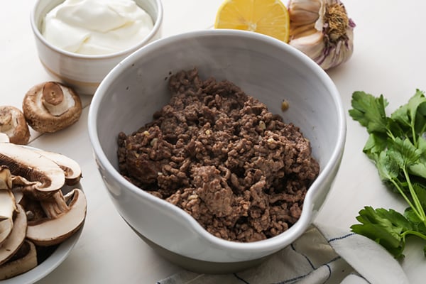 Crumbled cooked beef in a bowl.