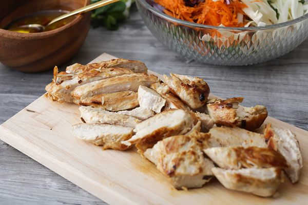 Chopped grilled chicken on a cutting board.