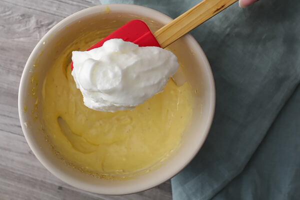 Mixing egg whites into batter.