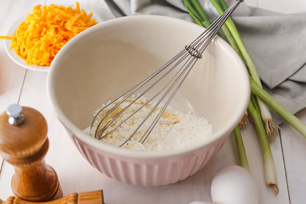 Mixing together dry ingredients.