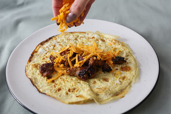 Adding filling to the enchiladas.