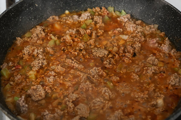 Meat cooking in a skillet.