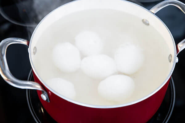 Boiling eggs in water.