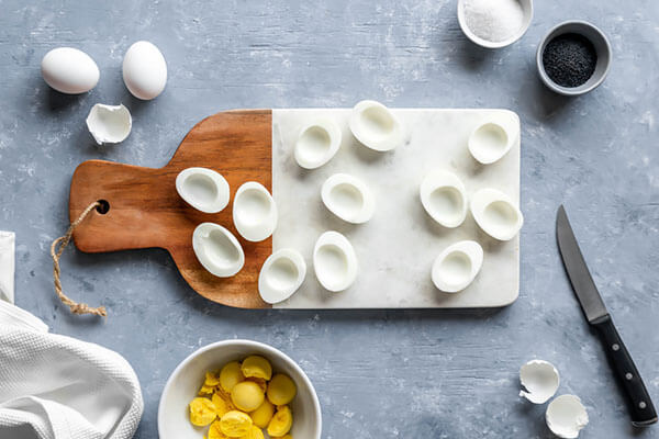 Halving eggs for deviled eggs.