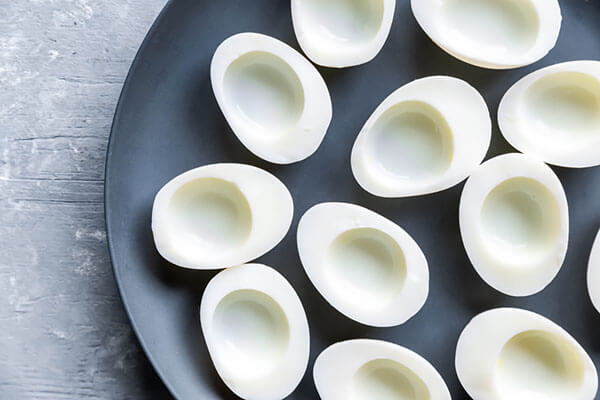 Empty hard boiled eggs on a plate.