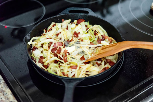 Frying cabbage with bacon.