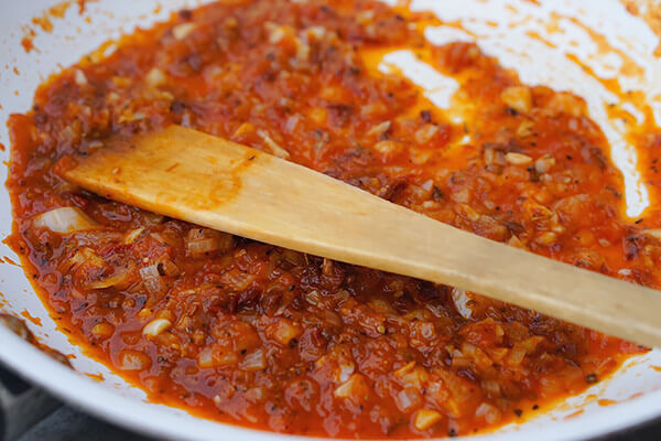 Cooking ranchero sauce in a skillet.
