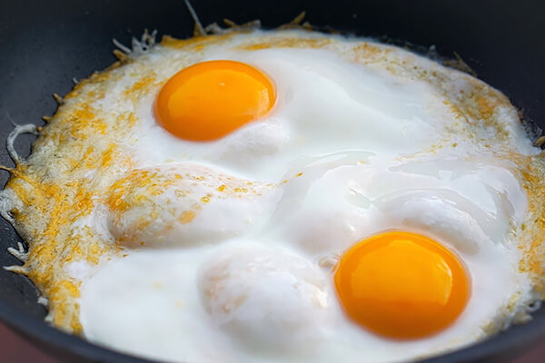Cooked eggs in a skillet.
