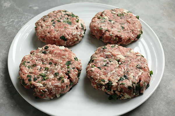 Forming the meat into burger patties.
