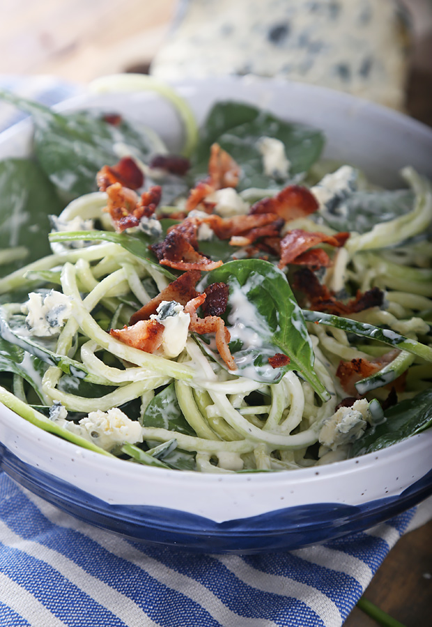 Zoodle salad tossed with spinach, crumbled bacon, blue cheese, and creamy dressing