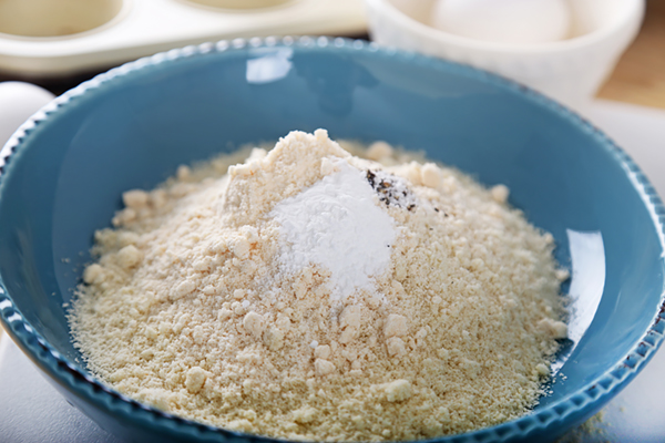 Almond flour, coconut flour, baking powder, salt, and pepper in a blue bowl