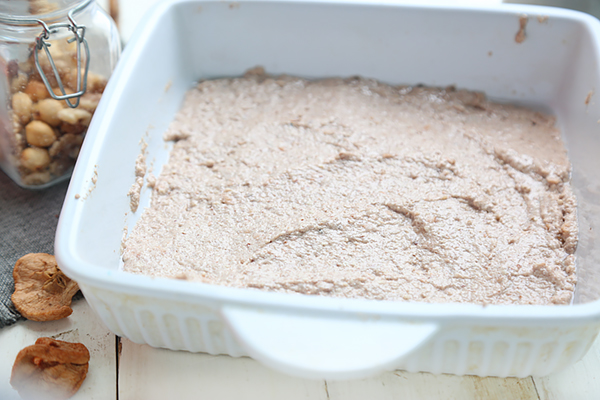 Apple cinnamon bar batter spread into a white baking dish before baking