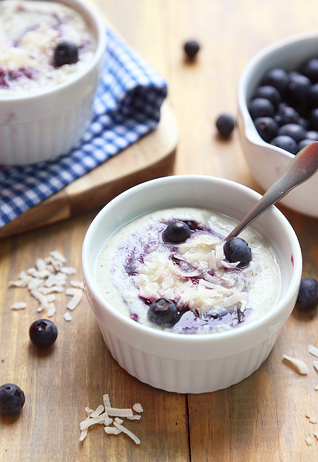 Set hemp seed yogurt topped with blueberries and shredded coconut in white ramekins
