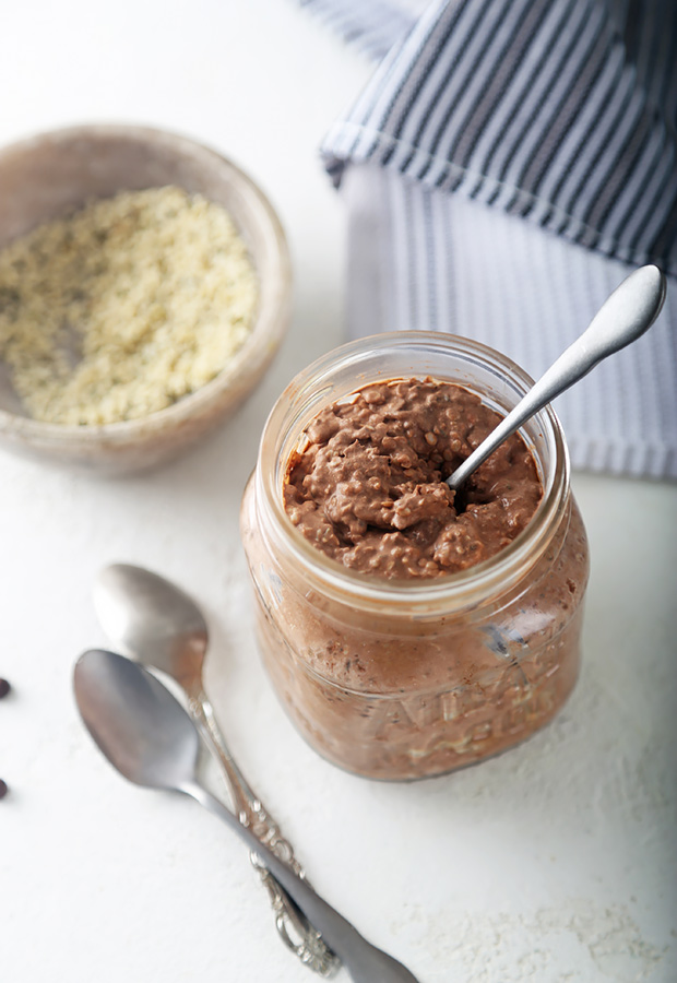 Dark chocolate overnight oatmeal thickened with hemp hearts and chia seeds in a mason jar