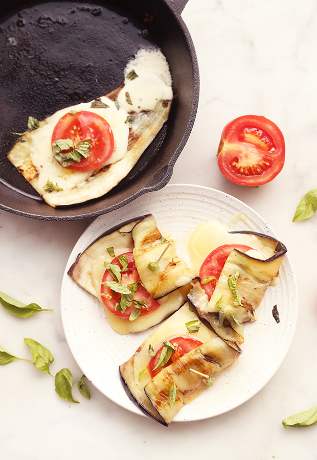 Grilled eggplant rolls stuffed with mozzarella, tomato, and basil secured with toothpicks