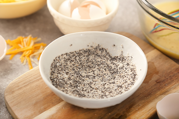 Psyllium husk powder, baking powder, and chia seeds mixed in a small white bowl