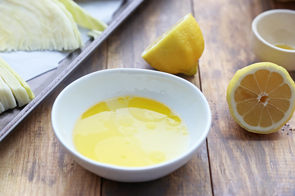 Olive oil and lemon juice whisked together in a small round bowl