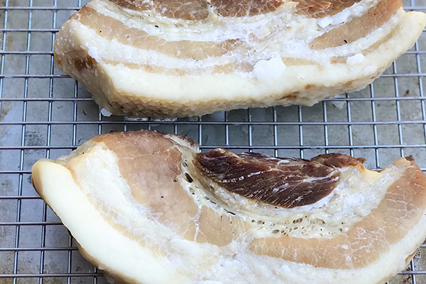 Before and after comparison of pork belly dried overnight on a wire rack