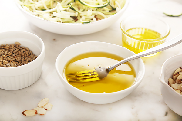 Avocado oil, white vinegar, and stevia whisked together with a fork in a small bowl