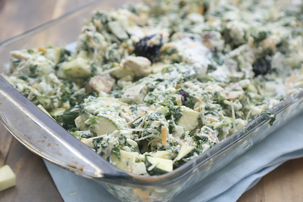 Chicken and spinach casserole filling spread in a glass baking dish