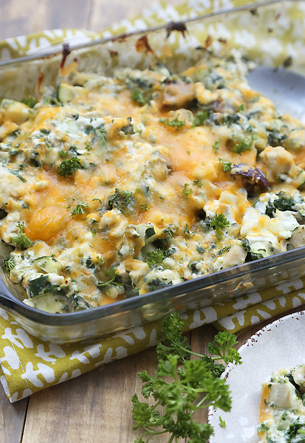 Baked chicken vegetable casserole with browned melted cheddar on top in a glass dish