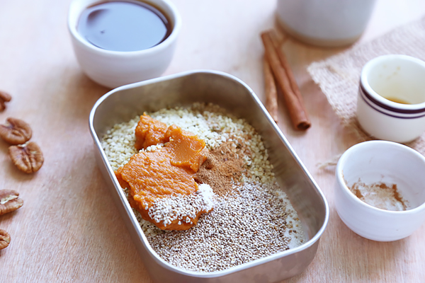 Pumpkin puree, chia seeds, hemp hearts, and pumpkin pie spice in a metal container