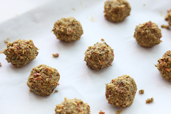 Walnut and herb falafel balls rolled and spaced on parchment paper