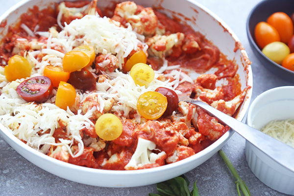 Halved cherry tomatoes and shredded mozzarella mixed into the cauliflower and tomato sauce