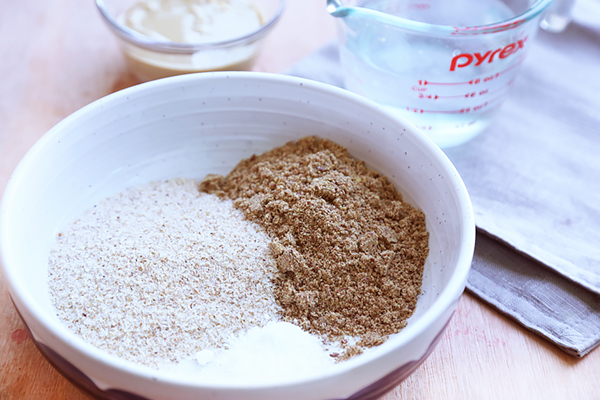 Psyllium husk powder, flaxseed meal, baking powder, and salt measured into a mixing bowl