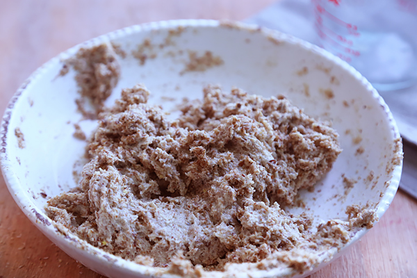 Dense bagel dough from psyllium husk, flaxseed meal, and tahini mixed together in a bowl