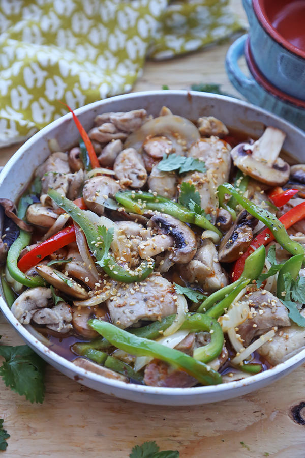 Finished chicken cacciatore with mushrooms, bell peppers, and herbs simmering in a skillet