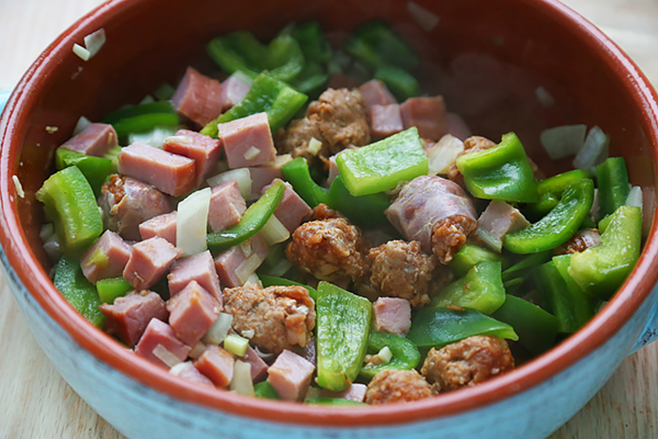 Cubed ham and chicken sausage stirred into the sauteed peppers and onion
