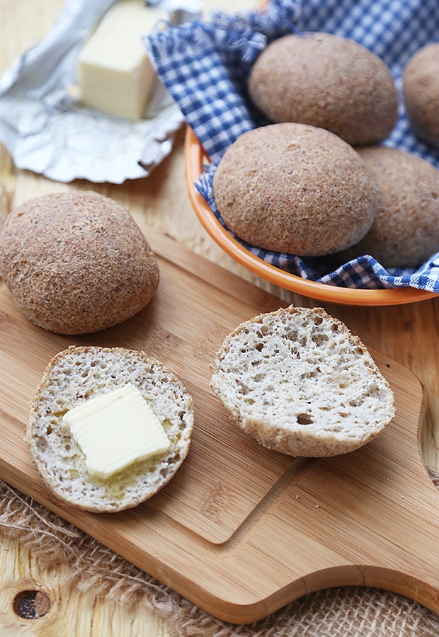Almond flour sandwich buns sliced open with butter, showing airy crumb inside